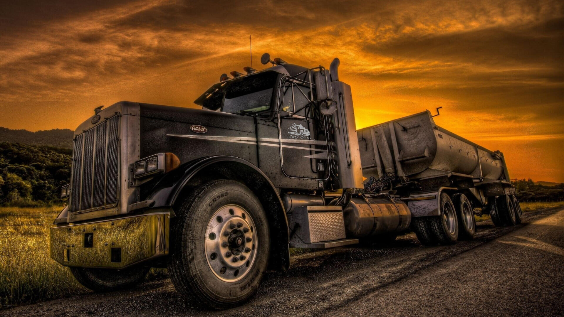 J&S Carter Peterbilt dump truck at sunset